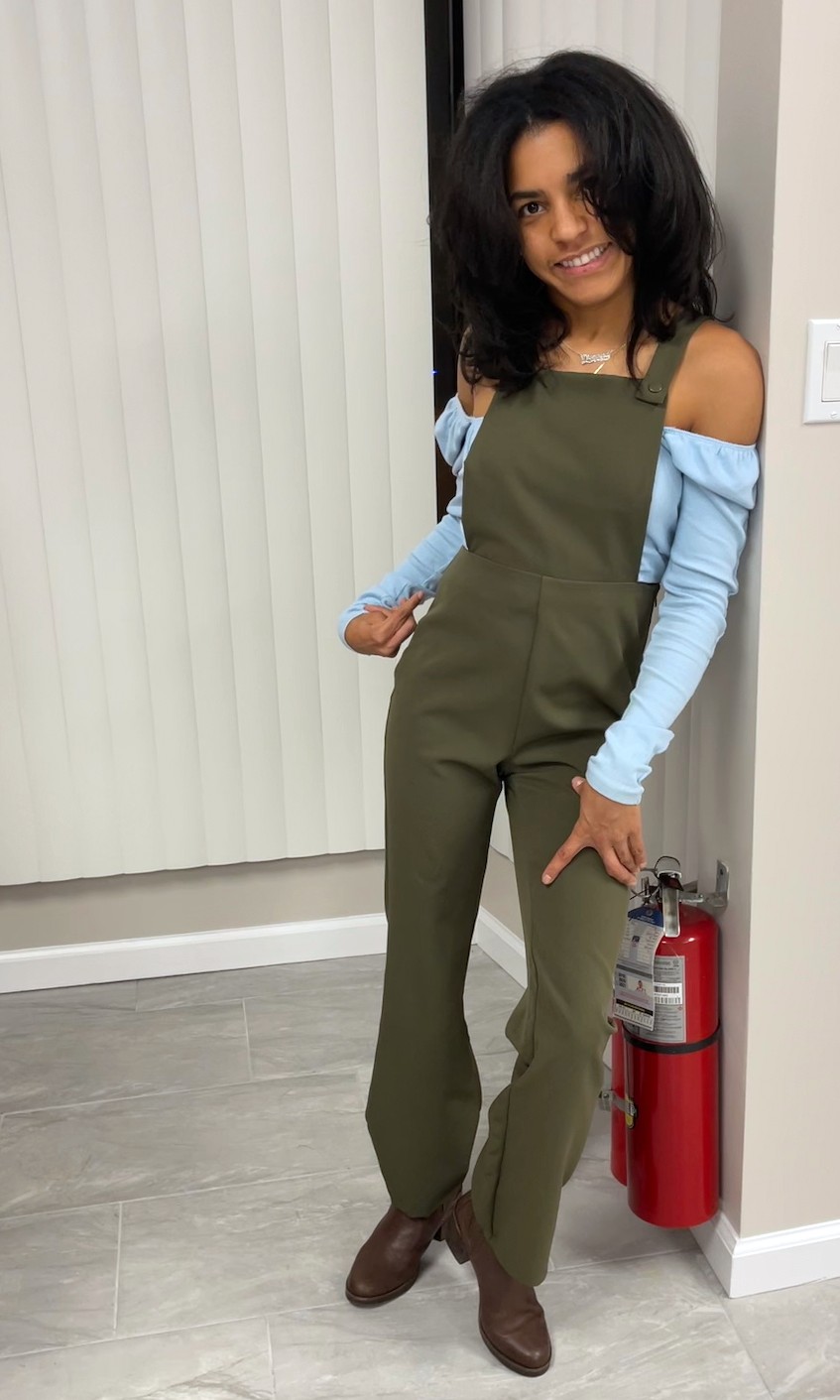 Image of a person with a disability looking straight and smiling to the camera while leaning on a wall.  She is wearing an olive green color overall with a baby blue long sleeves shirt. 


"Journey to Self-Acceptance with a Disability: Overcoming Limited Beliefs."